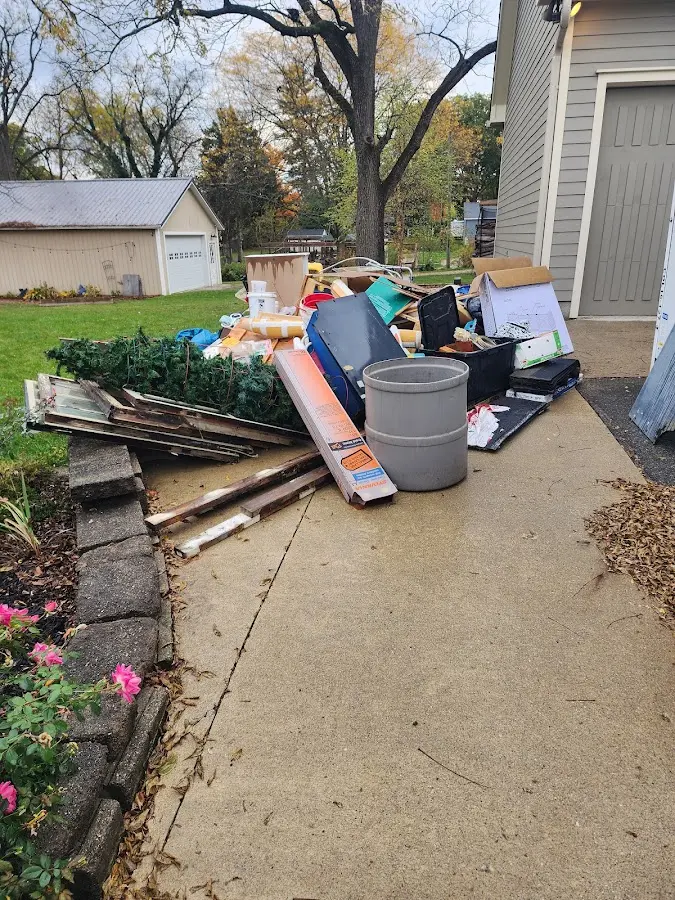 Dumpster being loaded with debris for Commercial Dumpster Rental in Crystal Lake